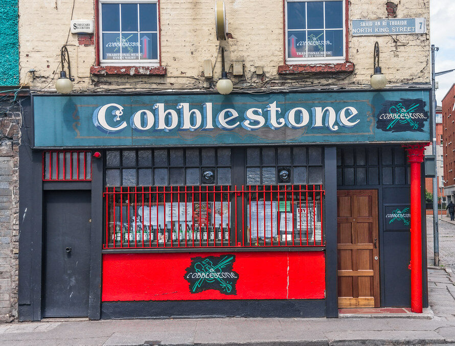 Green and red painted exterior of the Cobblestone Pub