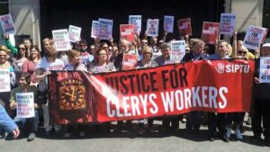 Clerys workers holding a Justice for Clerys banner outside the closed shop