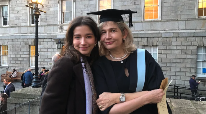 Martha Lovett Cullen, pictured on the left, with her mother Marian on the right. This picture was taken on Marian's graduation day and Marian can be seen wearing a graduation cap and robes.